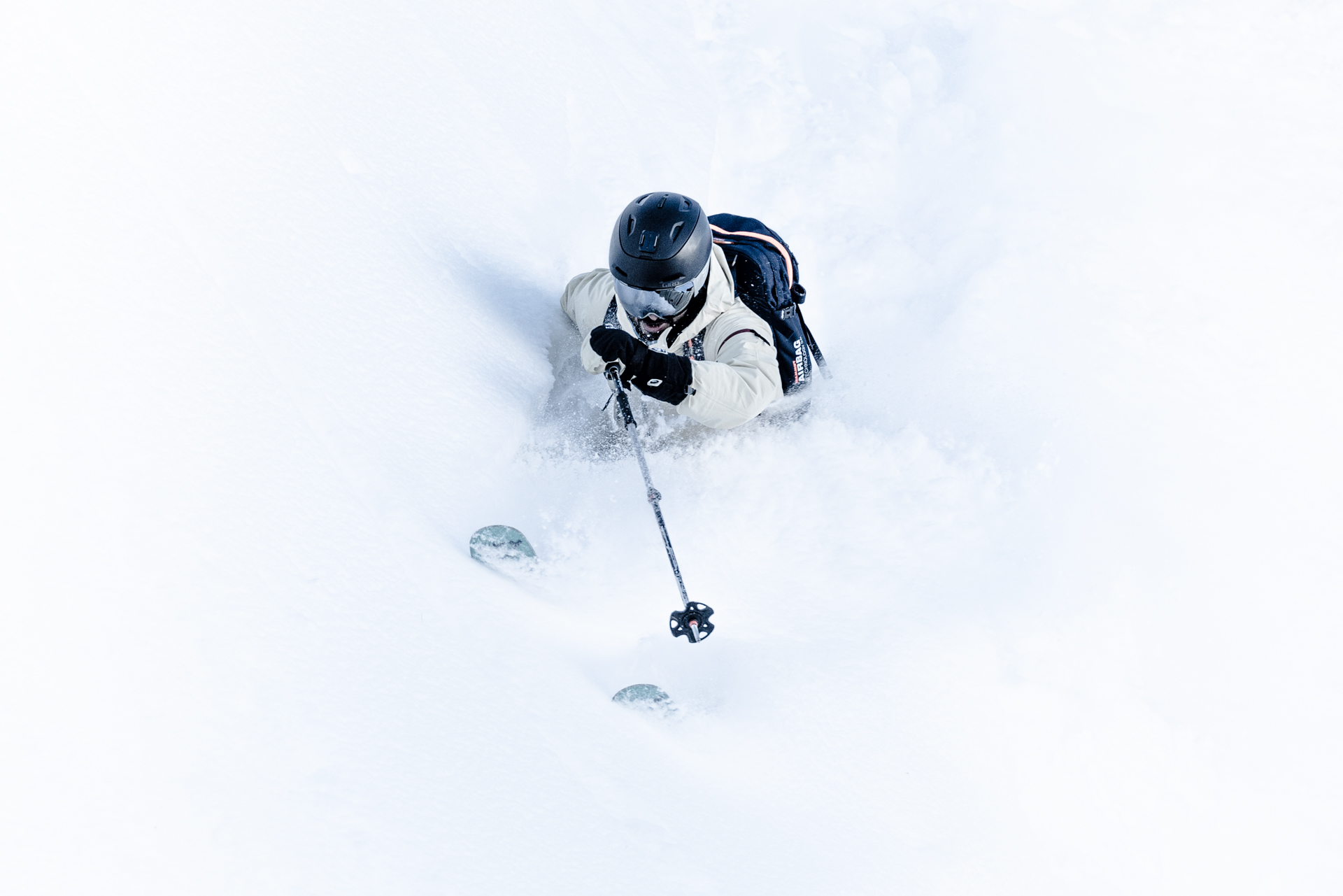 This is a photo of Nature, Outdoors, Piste, Snow, Sport, Clothing, Glove, Helmet, Adult, Male, Man, Person, Leisure Activities, Skiing